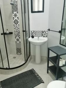 a white bathroom with a shower and a sink at Die Tuis Huis Selfcatering NO LOADSHEDDING in Worcester +40 photos