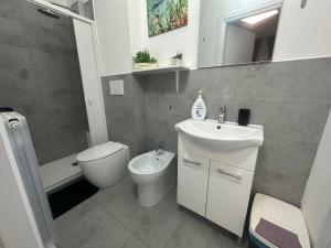 a bathroom with a sink and a toilet and a shower at B&B Le Palme Fiera in Bologna