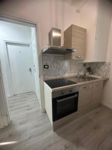 a kitchen with a sink and a stove at B&B Le Palme Fiera in Bologna