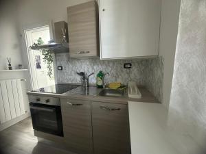 a kitchen with a sink and a counter top at B&B Le Palme Fiera in Bologna