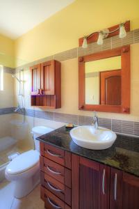 a bathroom with a sink and a toilet at Ocean Dream High Ceiling Studio w/balcony in Cabarete