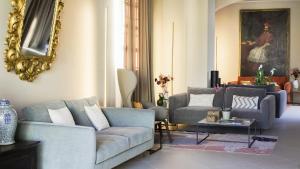 a living room with two couches and a table at Locanda del lupo in Soragna