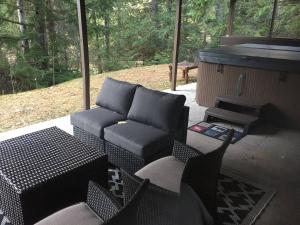 a living room with a couch and a grill at Hot Tub Ski In 10 Min Walk to the Lifts in Fernie