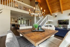 a dining room and living room with a wooden table at Hot Tub Ski In 10 Min Walk to the Lifts in Fernie +26 photos