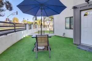 a table with an umbrella on the grass at Work and Play! North Hills Studio 15 Mi to Hollywood in North Hills