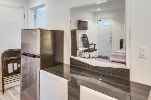 a kitchen with a refrigerator and a bedroom at Work and Play! North Hills Studio 15 Mi to Hollywood in North Hills