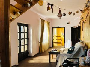 a living room with a couch and a table at Pensiunea Casa Ancutei in Ranca