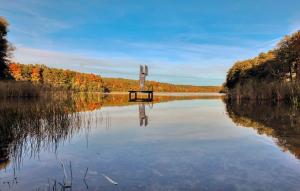 a view of a lake with a boat in the water at Ferienhaus Boitzenburger Land in Rosenow +17 photos