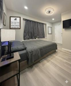 a bedroom with a bed and a desk and a television at Town & Country Andover, NJ Area- Studio Unit in Newton