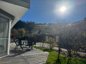 a deck with chairs and a table on a house at Alpenruhe Kranzegg in Rettenberg