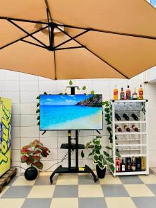 a flat screen tv on a stand in a room at Eliass Palace in Cotonou