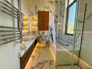 a bathroom with a sink toilet and a shower at Villa Saguramo in Saguramo