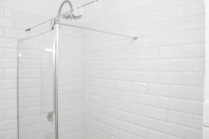 a shower with a glass door in a bathroom at The Diplomat Studio by Cape Living in Cape Town