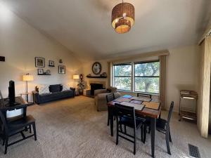 a living room with a table and a couch at The Treehouse on Table Rock in Eureka Springs