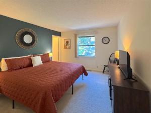 a bedroom with a bed and a television in it at The Treehouse on Table Rock in Eureka Springs