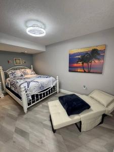 a bedroom with a bed and a bench in it at BEACHFRONT OCEANVIEW BALCONY GAMES POOL 75 TV in Cape Canaveral