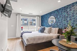 a bedroom with a bed and a blue wall at Chick and Cozy Haven near Banff with Hot tub and Pool in Canmore