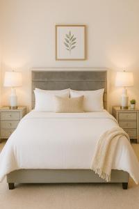 a bedroom with a large white bed with two night stands at Modern Private Room with Private Bath in Manteca +2 photos