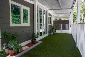 a screened porch with green grass and plants at Coqui Tiny House - Unit 1 in Rincon