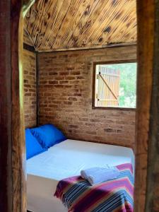 Ένα ή περισσότερα κρεβάτια σε δωμάτιο στο Chalé rústico Nhá Chica