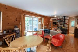 a living room with a table and chairs at Secluded Cabin With Ocean Access in Tremont