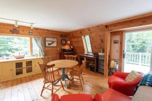 a kitchen and living room with a table and chairs at Secluded Cabin With Ocean Access in Seal Cove +10 photos