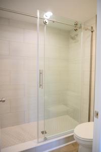 a glass shower with a toilet in a bathroom at Coastal Luxury Studio One Block to Big Rock in Morehead City
