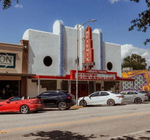 a group of cars parked in front of a theater at Hotel Daphne in Houston