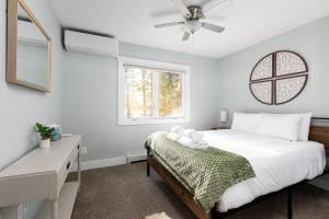a bedroom with a bed and a ceiling fan at The Long Lake Escape in Traverse City