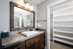 a bathroom with a sink and a mirror at The Long Lake Escape in Traverse City +50 photos