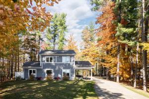 a home in the woods in the fall at The Long Lake Escape in Traverse City