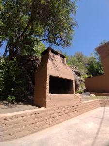 a brick dog house sitting on top of a sidewalk at Cabañas Los Pinos in Potrero de los Funes