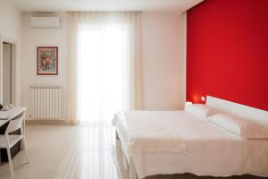 a bedroom with a white bed and a red wall at Pantarei Palace in Lettere +54 photos