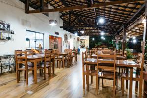 a dining room with wooden tables and chairs at Pousada Boa Vista in Barreirinhas