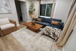 a living room with a blue couch and a table at Modern Stylish Comfort Near Casino and Hwy in East Hazel Crest