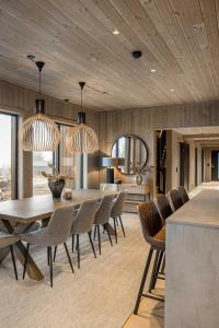 a dining room with a table and chairs at TH2115- Premium chalet in Trysilfjell with jacuzzi, sauna, shuttle bus in Trysil
