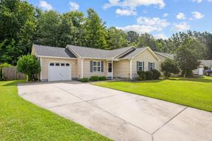 a house with a driveway and grass at 3 Bedroom Home with King Bed, Fenced Yard & Pool Table in New Bern