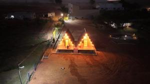 a small house in the middle of a street at night at Chalés JH in São Roque de Minas +5 photos