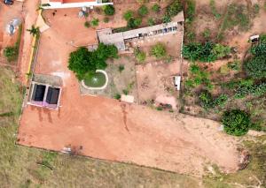 an aerial view of a dirt yard with a building at Chalés JH in São Roque de Minas