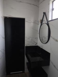 a bathroom with a black sink and a mirror at Chalés JH in São Roque de Minas