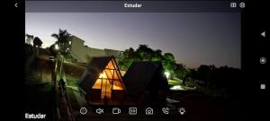 a screen shot of a lit up house at night at Chalés JH in São Roque de Minas