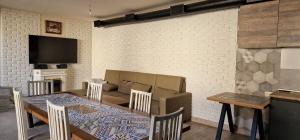 a dining room with a table and a couch at Zeytoun Guest House in Yerevan