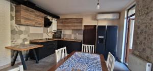 a kitchen with a table and a dining room at Zeytoun Guest House in Yerevan