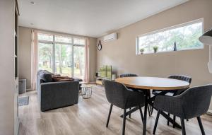 a living room with a table and a couch at 2 Bedroom Stunning Home In Hellendoorn in Hellendoorn