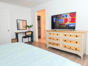a bedroom with a television on top of a dresser at Modern Luxury House 3B&4B House 30 mins DTLA in Baldwin Park