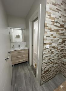 a bathroom with a sink and a mirror at Grey House in Huelva