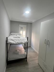a room with two bunk beds and a closet at Grey House in Huelva +2 photos