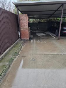 a garage with a car parked in it at Mary Magnolia in Craiova