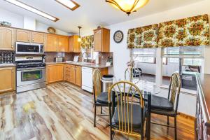 a kitchen with wooden cabinets and a table and chairs at Mtn Gate Guest House about 6 Mi to Shasta Lake! in Shasta Lake