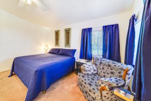 a bedroom with a bed and a couch and blue curtains at Mtn Gate Guest House about 6 Mi to Shasta Lake! in Shasta Lake